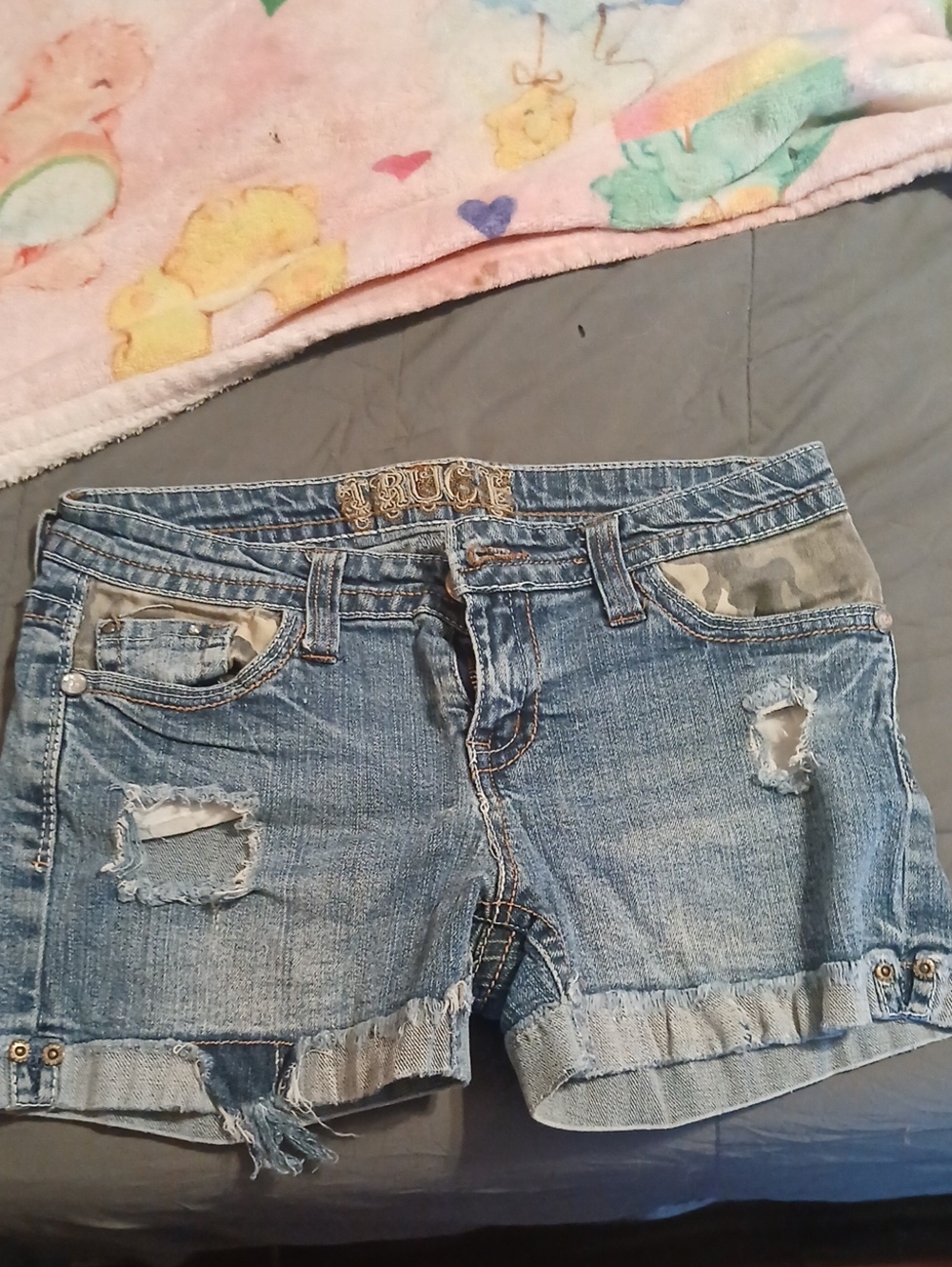 Ripped Denim Women’s Shorts with Camo Trim